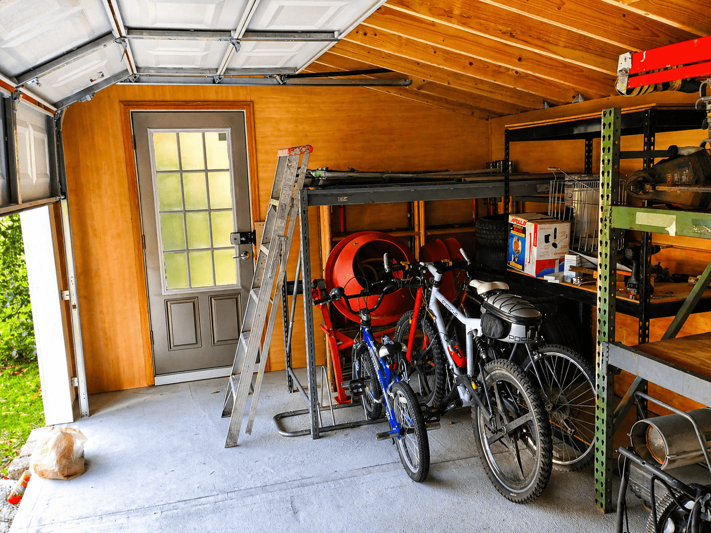 Inside the shed today through open garage door showing storage and use