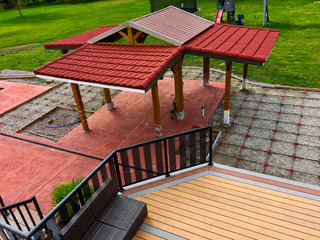 Gazebo roof extensions with fascia and stamped concrete patio in progress