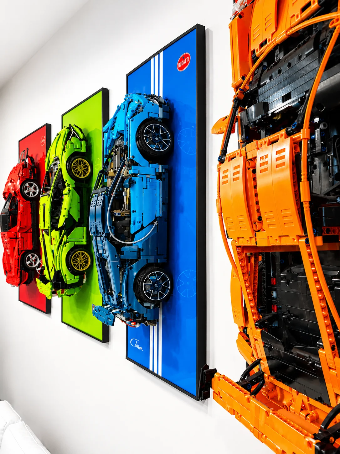 Hero shot of finished LEGO Technic wall art installation with five cars on dark painted wall