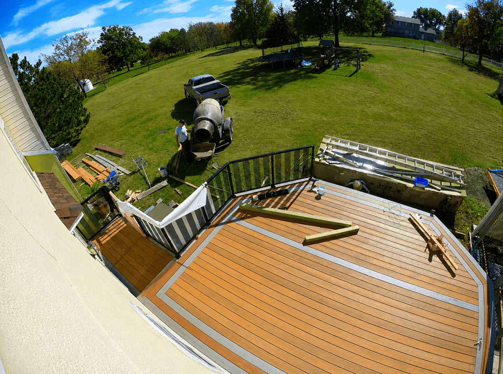 Deck framing with blocking between joists for structural support at railing post locations