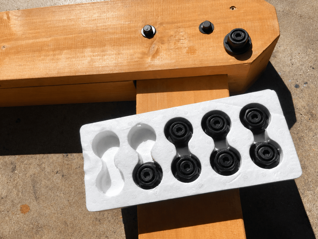 Installing Ozco decorative caps over the gazebo's stock bolts