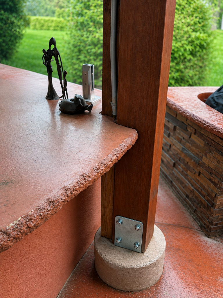 Outdoor kitchen countertop wrapping around the gazebo posts