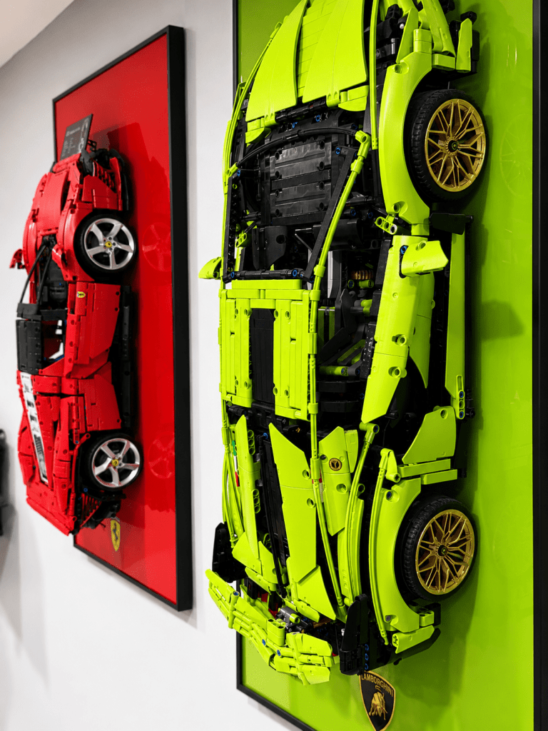 LEGO Technic McLaren in black acrylic display frame showing orange wheels and spoiler