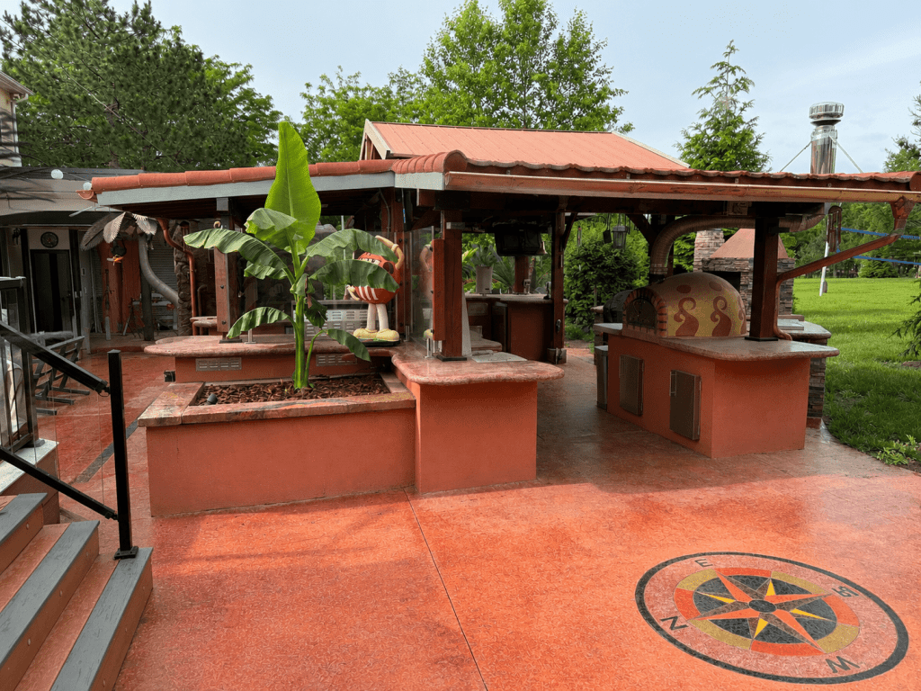 DIY outdoor kitchen with DECRA stone-coat metal roof and cedar gazebo structure completed