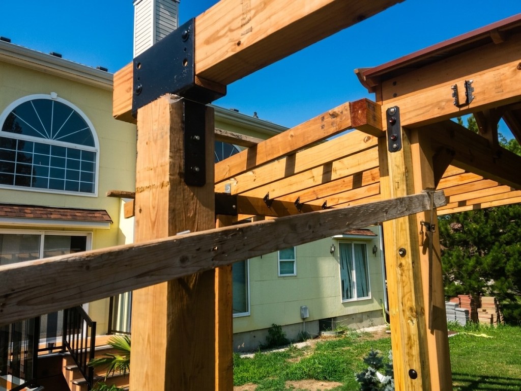 Black-painted Simpson column cap supporting a 6x4 beam