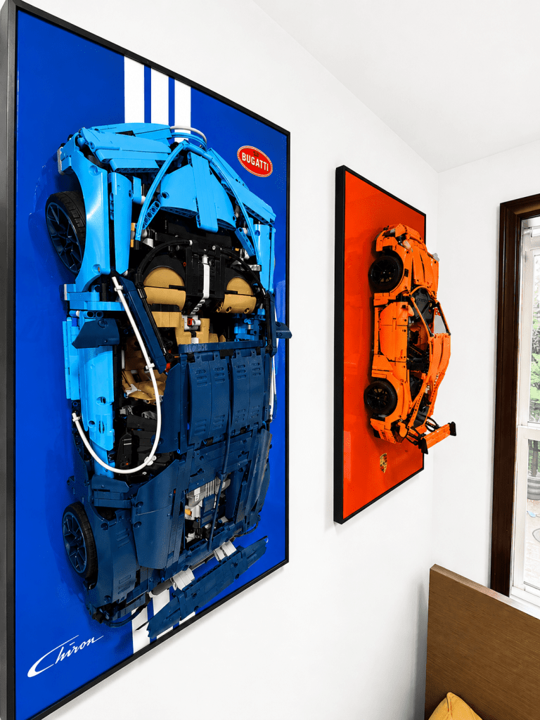 Full gallery wall of LEGO Technic supercars in matching black display frames